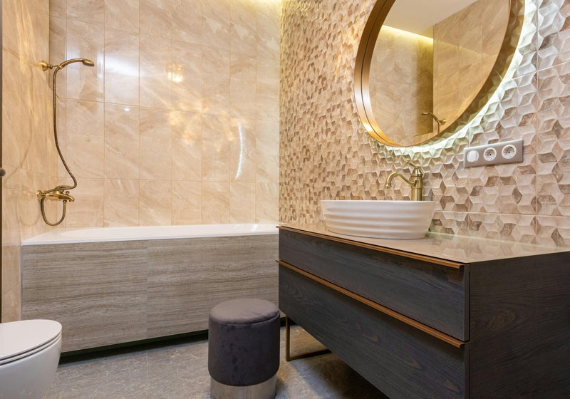 Luxury bathroom with walk-in shower and gold fixtures